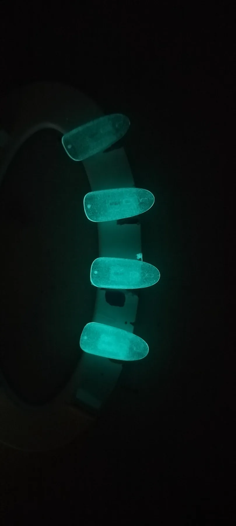 Glow-effect sample swatches photographed in low light to compare intensity and coverage.
