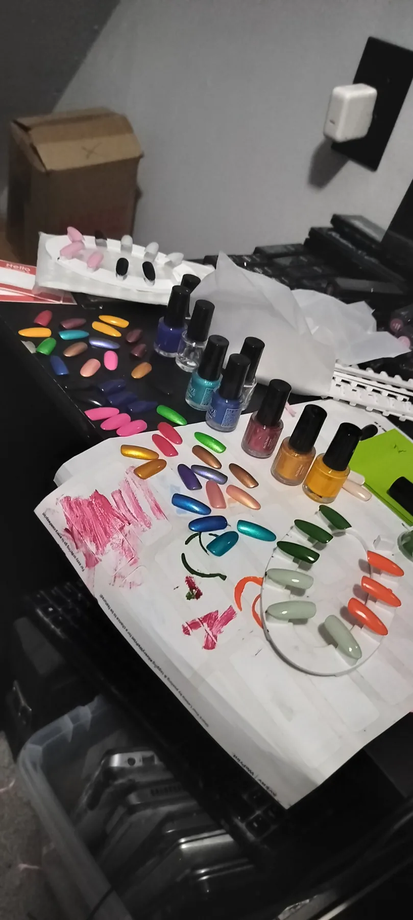 Product-development workspace with bottles, nail wheels, loose samples, and color tests.