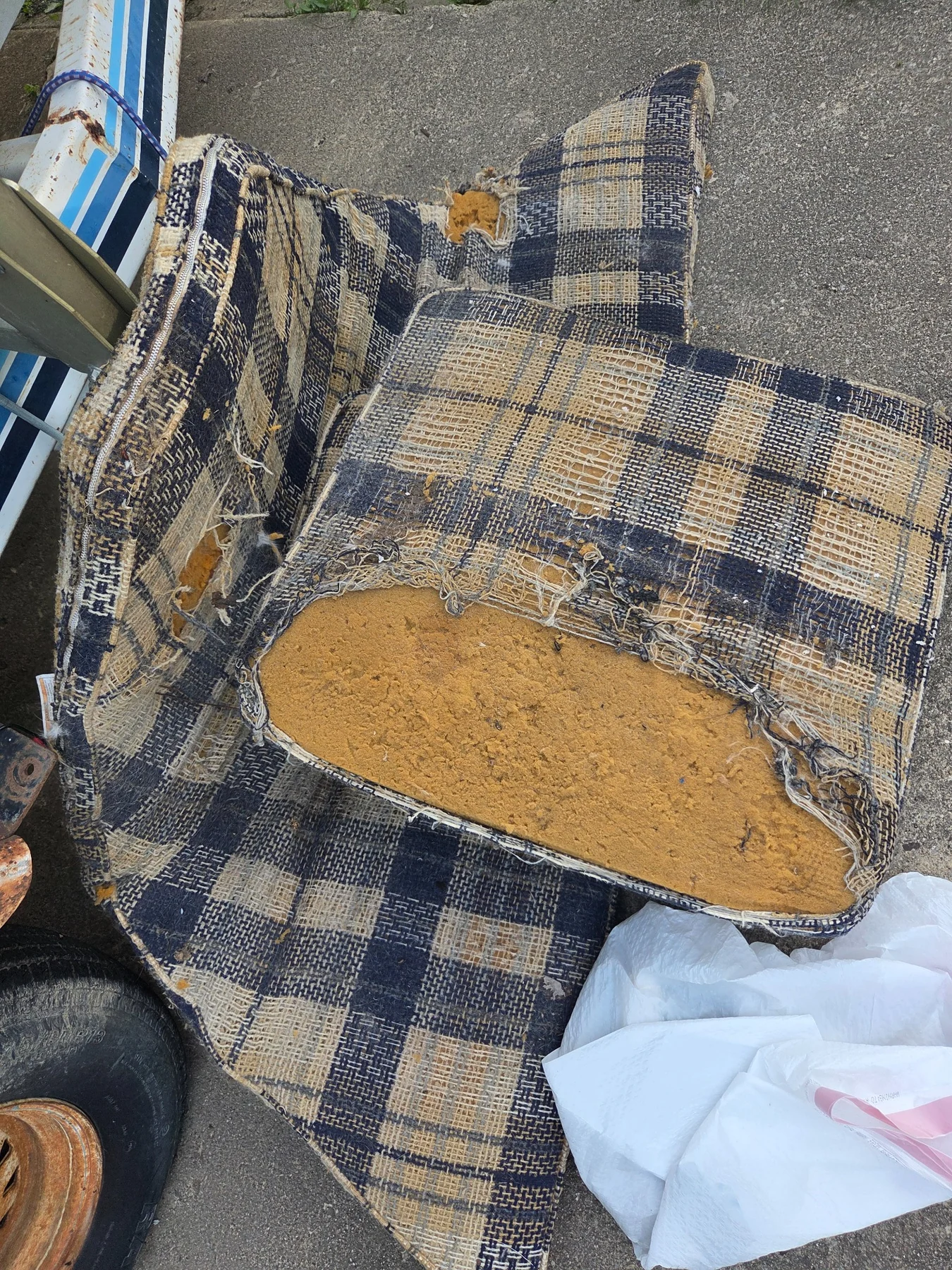 Original deteriorated seat and upholstery material before replacement and interior rebuild work.
