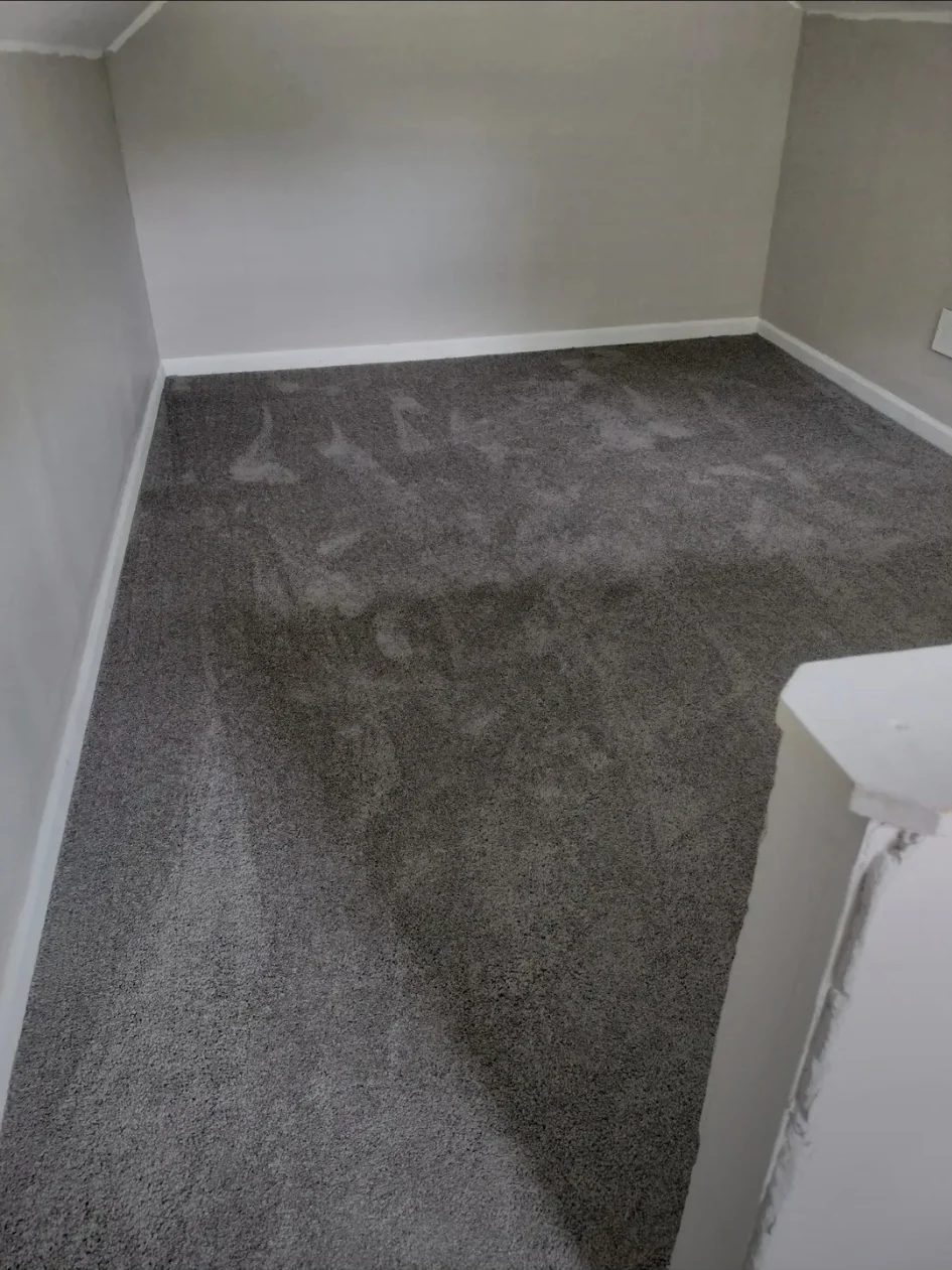 Upper room after paint, baseboard, and carpet installation.