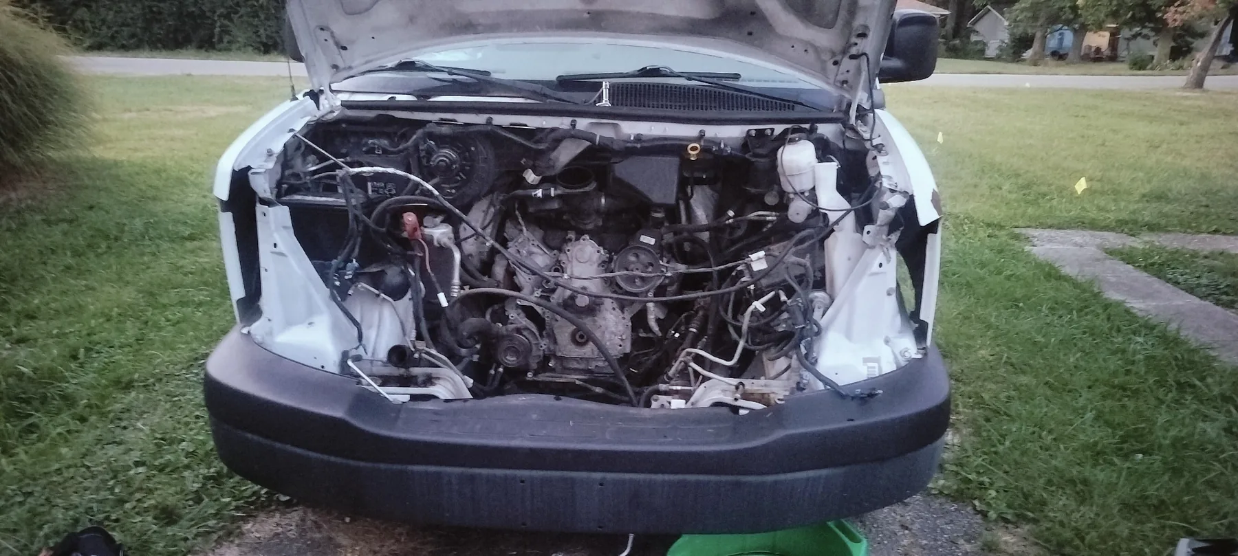 Chevrolet Express engine bay during front-engine teardown and repair.