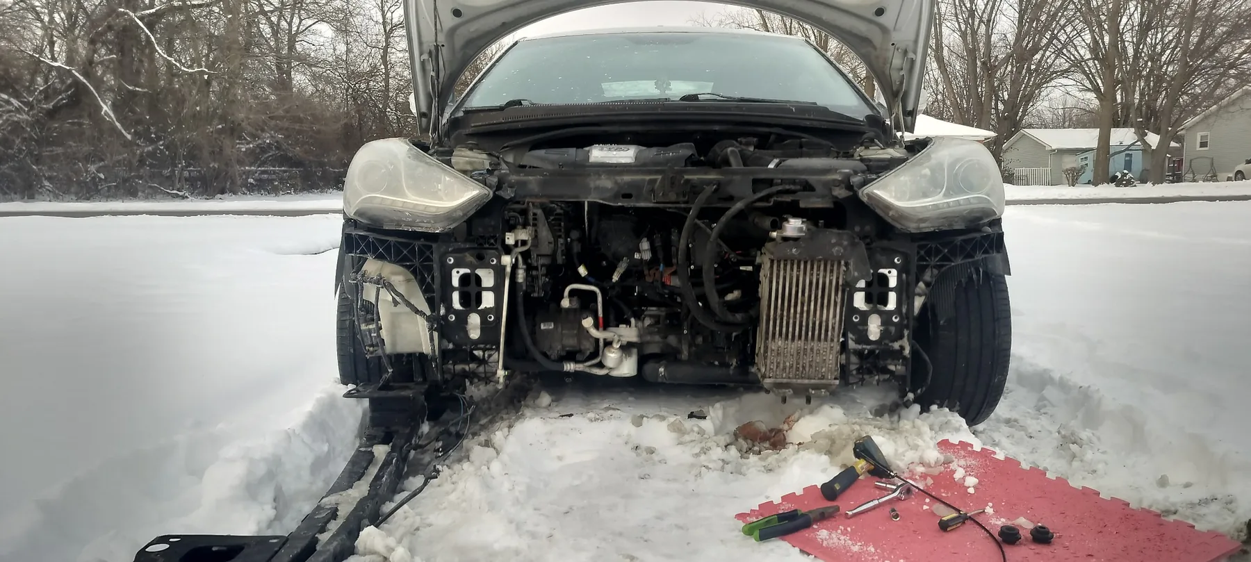 Front-end and cooling-package repair performed outdoors in winter conditions.